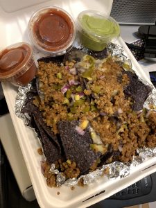 Beef Nachos with salsa and guacamole on the side from Greedi Vegan to Go